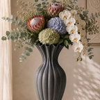 Basma Black Vase in rich black grained finish, side view showing fluted bottle silhouette