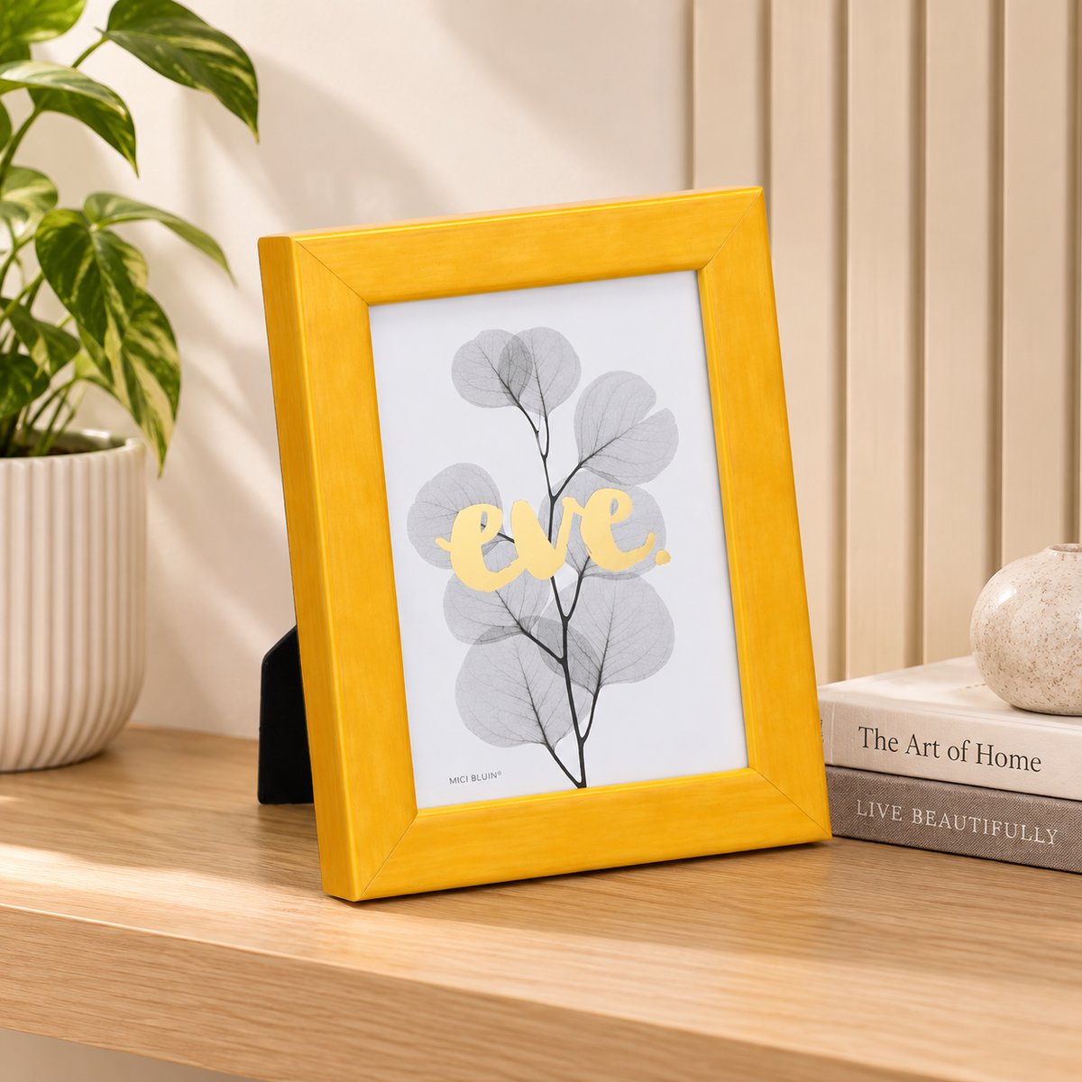 Gelati Yellow by Eve photo frame in bright yellow high-gloss resin, angled view showing rounded profile