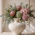 Lexi Vase in white textured grained finish, side view showing rounded silhouette
