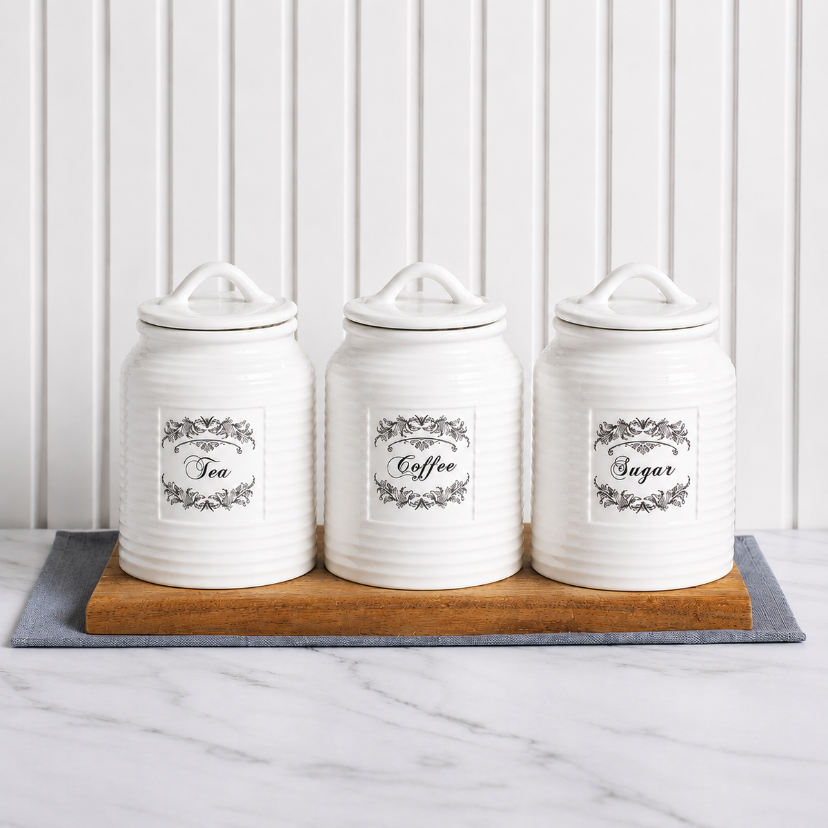 Country Cottage Canister Set in white ceramic with vintage-style detailing, cylindrical canisters